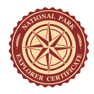 Red Round Logo with a compass rose star in the middle and text that reads National Park Explorer Certificate