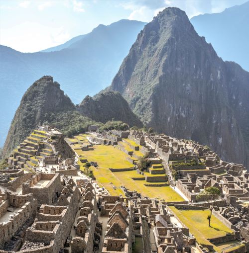 An aerial view image of Machu Picchu UNESCO World Heritage Site in Peru next to a large mountain, the aerial view looks down on the Grand Sanctuary ruins of the ancient Aztec community that lived there 700 years ago